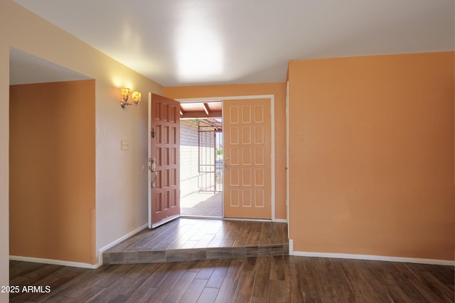 foyer entrance featuring baseboards and wood finished floors