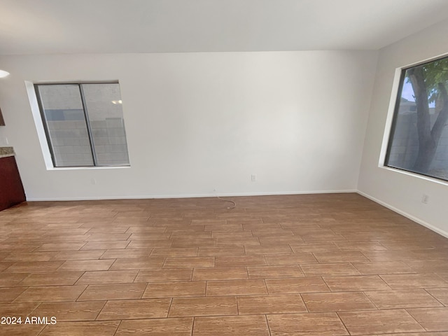 empty room featuring baseboards and wood tiled floor