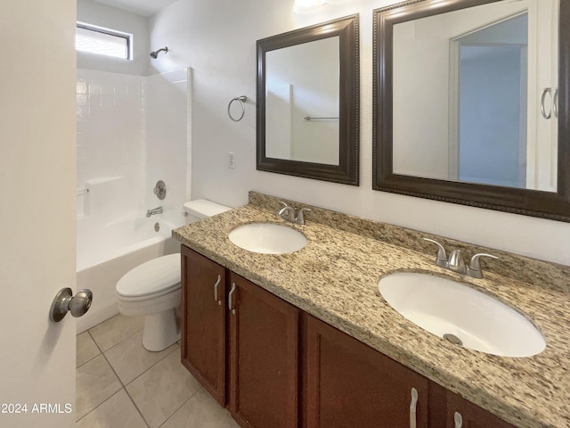 full bath with tile patterned flooring, double vanity, toilet, and a sink