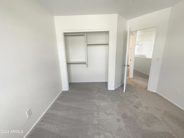 unfurnished bedroom with baseboards, a closet, and carpet floors