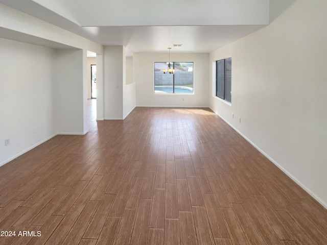 unfurnished room with dark wood-style floors and baseboards