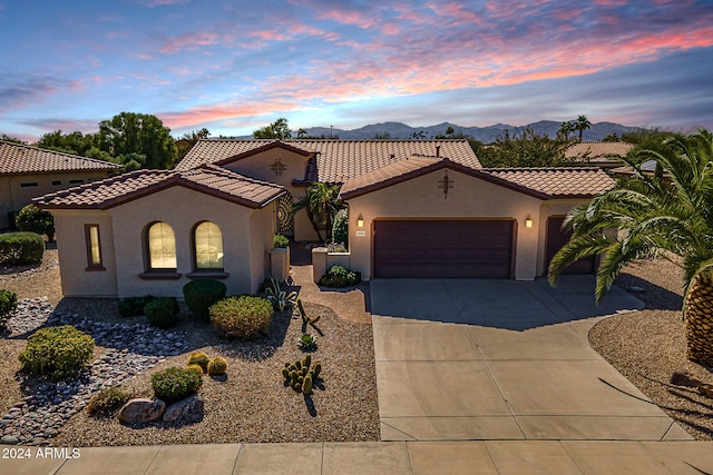 mediterranean / spanish-style home featuring a mountain view and a garage