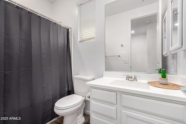 full bathroom featuring toilet, a shower with curtain, wood finished floors, and vanity