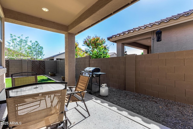 view of patio / terrace with area for grilling, outdoor dining space, and a fenced backyard