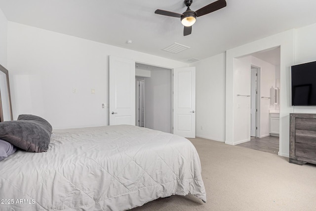 bedroom with visible vents, baseboards, ceiling fan, connected bathroom, and carpet