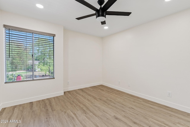 empty room featuring ceiling fan and light hardwood / wood-style floors