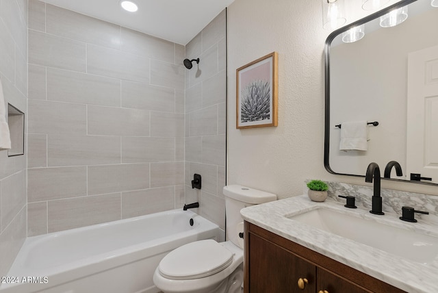 full bathroom with toilet, tiled shower / bath combo, and vanity