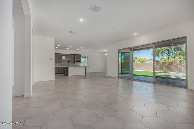 unfurnished living room with light tile patterned floors