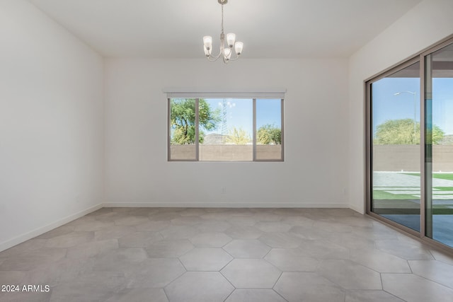 spare room featuring a notable chandelier