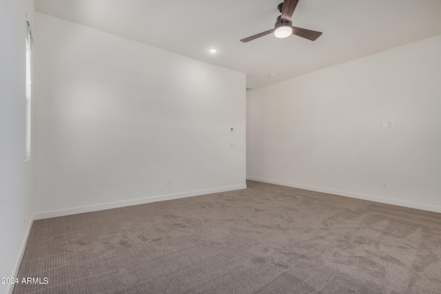 spare room featuring carpet and ceiling fan