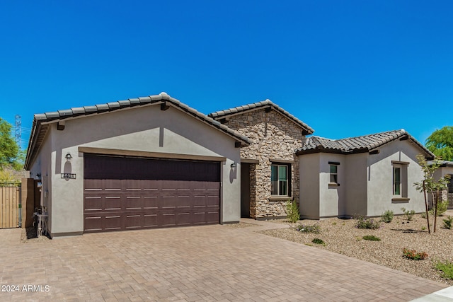 mediterranean / spanish home featuring a garage