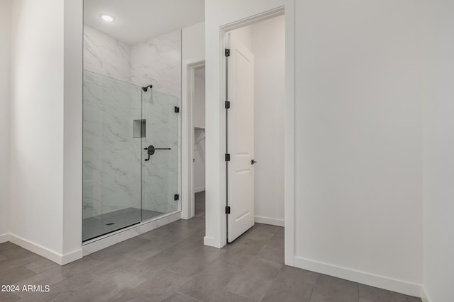 bathroom featuring a shower with door