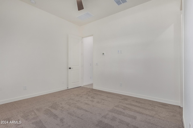 spare room with light carpet and ceiling fan