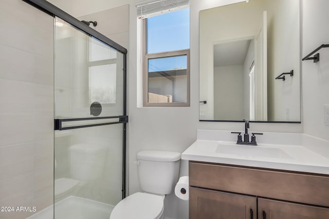 bathroom with toilet, walk in shower, and vanity