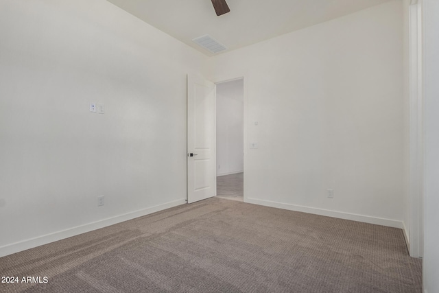 empty room with ceiling fan and carpet flooring