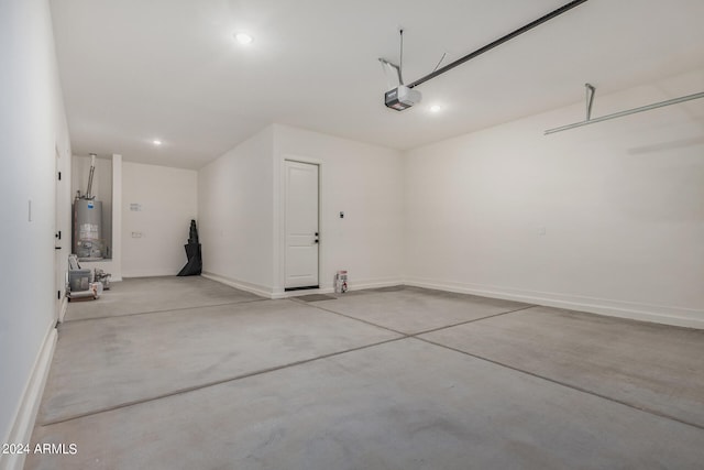 garage with a garage door opener and water heater