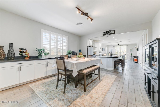dining room featuring visible vents and wood tiled floor