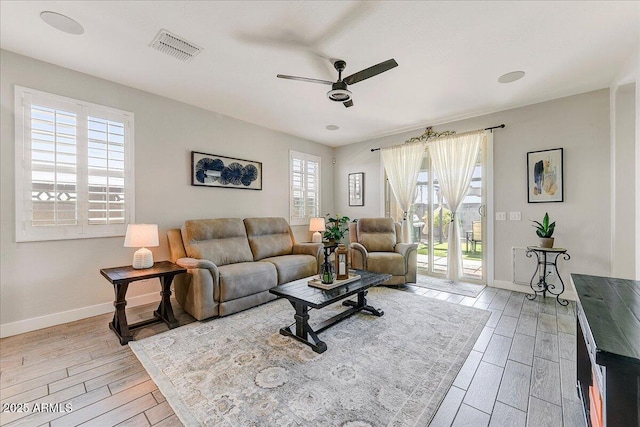 living area with visible vents, plenty of natural light, and light wood finished floors