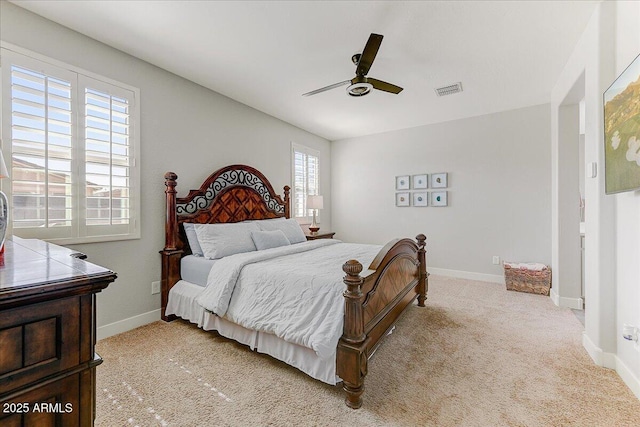 bedroom featuring visible vents, baseboards, light colored carpet, and ceiling fan