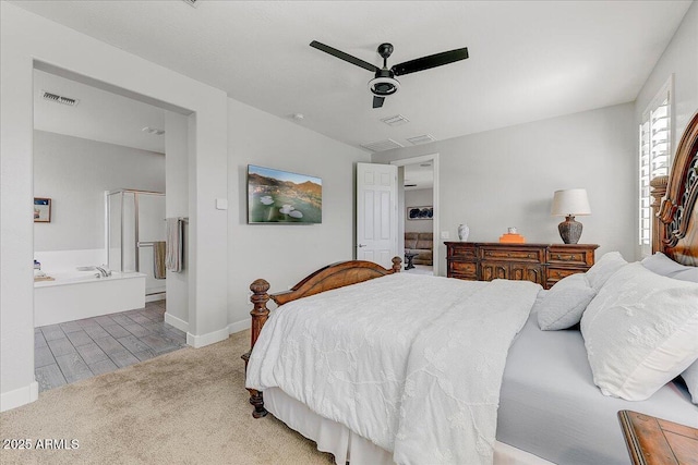 carpeted bedroom featuring a ceiling fan, baseboards, visible vents, and ensuite bathroom