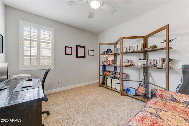 carpeted home office with baseboards, lofted ceiling, and ceiling fan