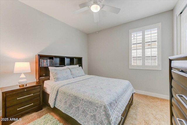 bedroom with ceiling fan, baseboards, and carpet floors
