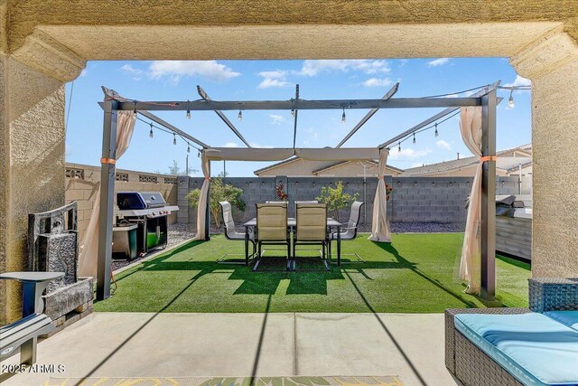 view of patio with grilling area and a fenced backyard