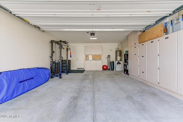 garage with gas water heater and a garage door opener