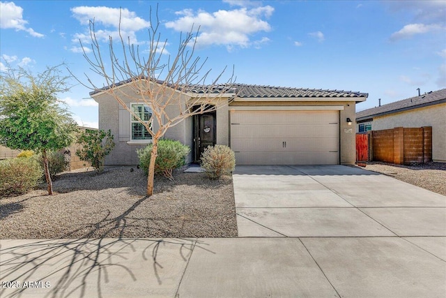single story home with fence, driveway, an attached garage, stucco siding, and a tile roof