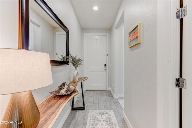 entryway with recessed lighting, baseboards, and wood finished floors