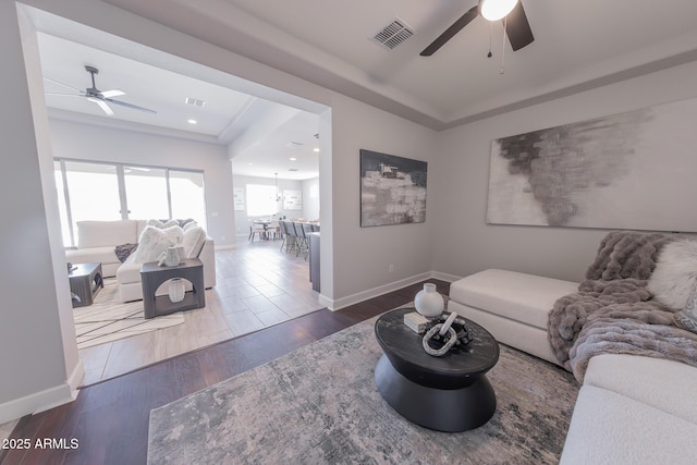 15248 S 182nd Ln, Goodyear, AZ 85338 - living room featuring a ceiling fan, wood finished floors, baseboards, and a tray ceiling