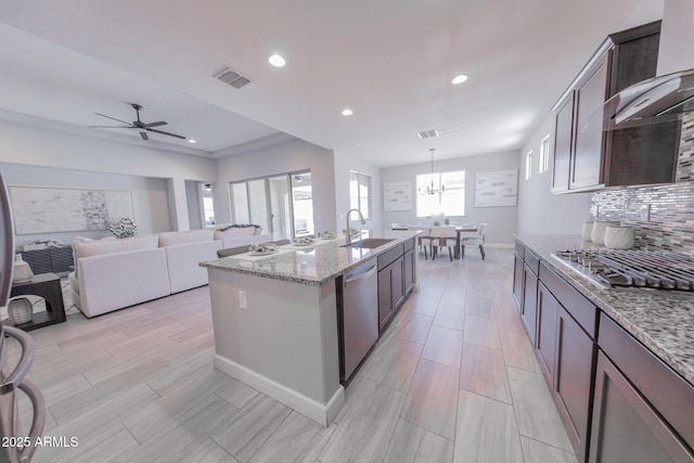 15248 S 182nd Ln, Goodyear, AZ 85338 - kitchen featuring appliances with stainless steel finishes, a sink, light stone counters, recessed lighting, and decorative backsplash