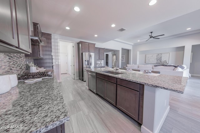 15248 S 182nd Ln, Goodyear, AZ 85338 - kitchen with a sink, stainless steel appliances, recessed lighting, backsplash, and dark brown cabinetry