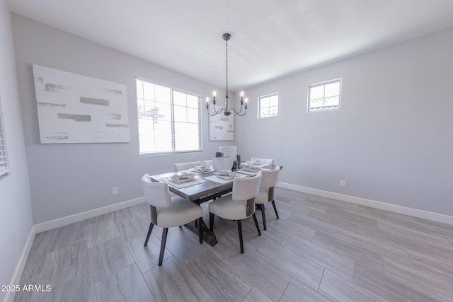 15248 S 182nd Ln, Goodyear, AZ 85338 - dining space with a chandelier, baseboards, and light wood finished floors
