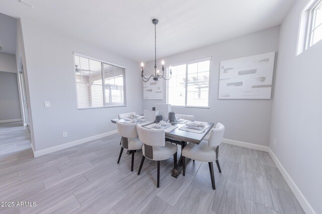 15248 S 182nd Ln, Goodyear, AZ 85338 - dining space with a chandelier, baseboards, and light wood finished floors