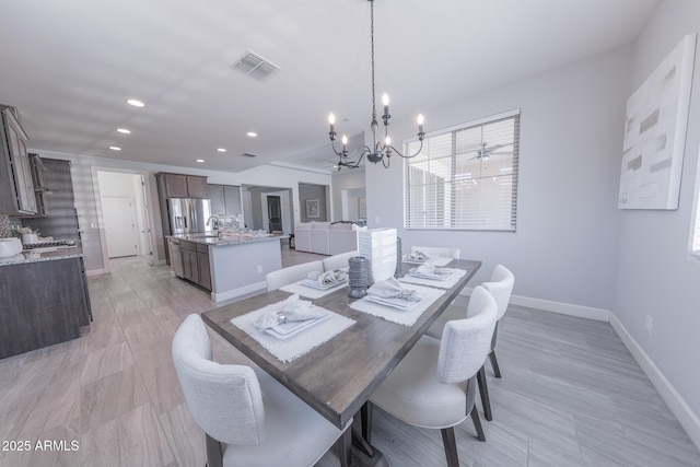 15248 S 182nd Ln, Goodyear, AZ 85338 - dining room with a chandelier, baseboards, recessed lighting, and light wood-style floors