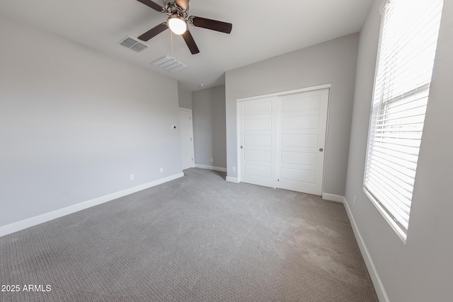 15248 S 182nd Ln, Goodyear, AZ 85338 - unfurnished bedroom featuring a closet, carpet, baseboards, and multiple windows