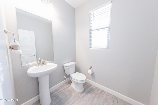 15248 S 182nd Ln, Goodyear, AZ 85338 - bathroom featuring toilet, baseboards, and a sink