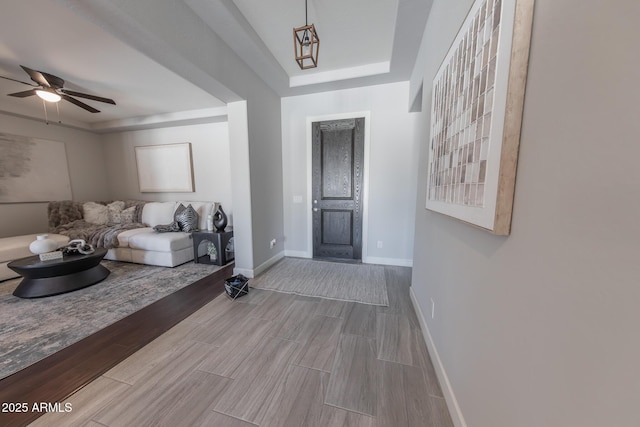 15248 S 182nd Ln, Goodyear, AZ 85338 - living area with wood finished floors, a ceiling fan, baseboards, and a raised ceiling