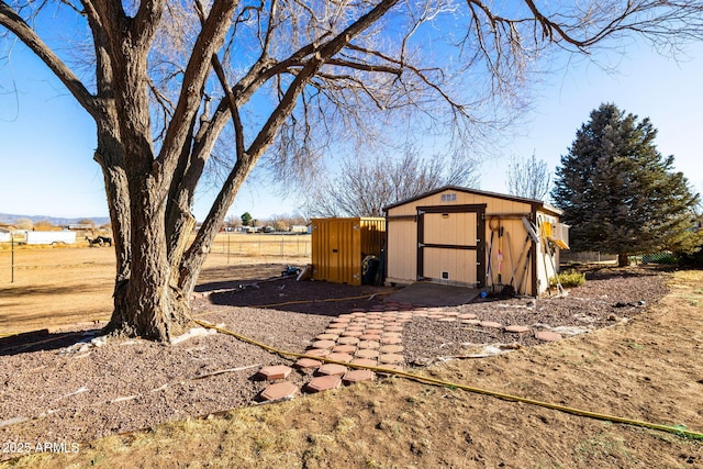 view of outdoor structure with a rural view