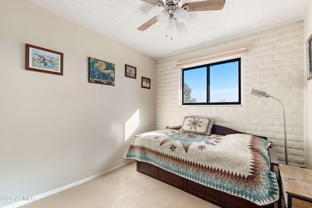 carpeted bedroom with ceiling fan and a textured ceiling