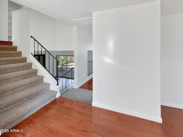 staircase featuring hardwood / wood-style floors