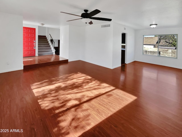 unfurnished living room featuring hardwood / wood-style flooring and ceiling fan