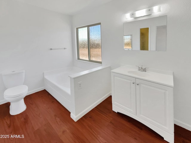 bathroom with vanity, toilet, wood-type flooring, and a washtub