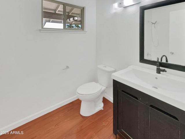 bathroom featuring vanity, wood-type flooring, and toilet