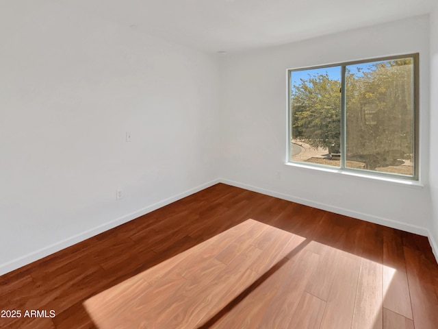 empty room with hardwood / wood-style floors