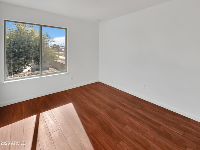 empty room with hardwood / wood-style flooring