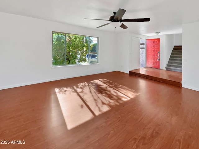 unfurnished living room featuring hardwood / wood-style floors and ceiling fan