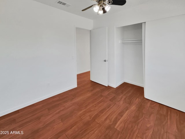 unfurnished bedroom featuring wood-type flooring, a closet, and ceiling fan