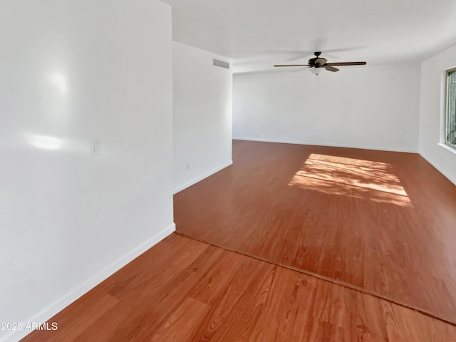 unfurnished room with ceiling fan and wood-type flooring